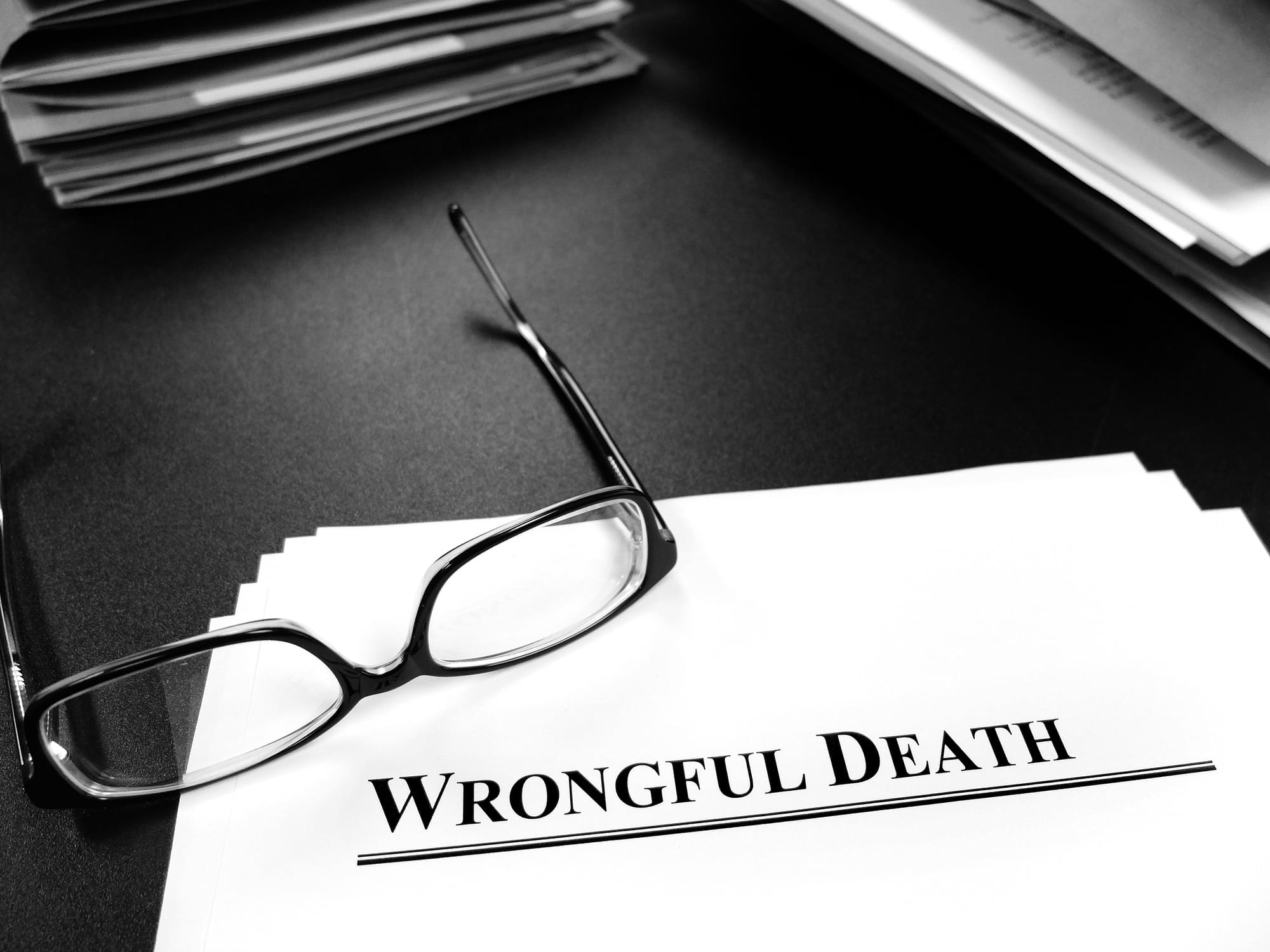 Eyeglasses on a Legal Document representing a Califiornia Wrongful Death Claim.